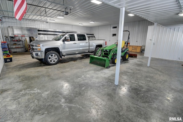 garage with a carport and a garage door opener