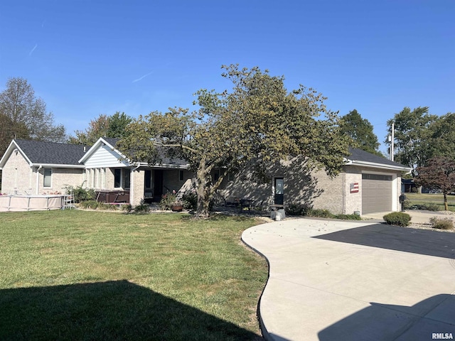 view of front facade with a garage and a front lawn