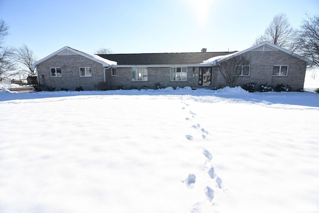 view of snow covered rear of property