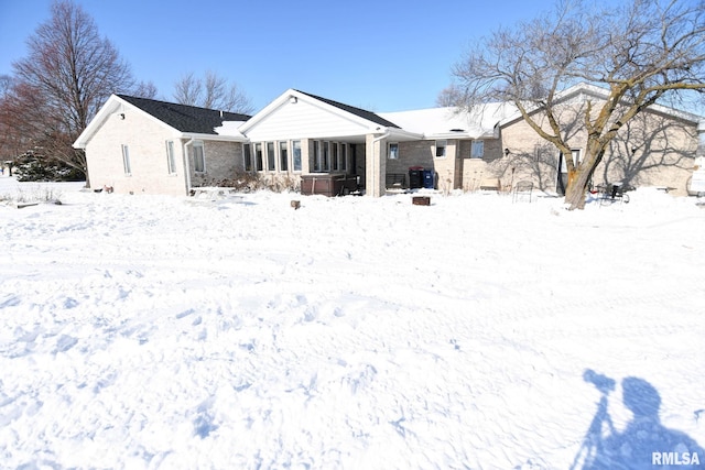 view of snow covered back of property