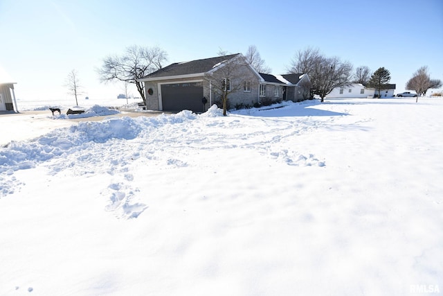 yard covered in snow with a garage