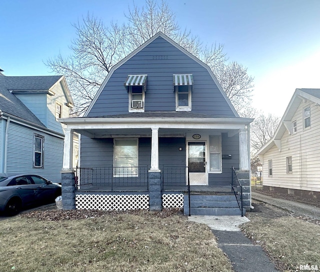 bungalow-style home featuring a porch and a front yard