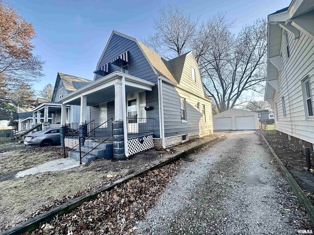 view of front of home with an outbuilding, a porch, and a garage