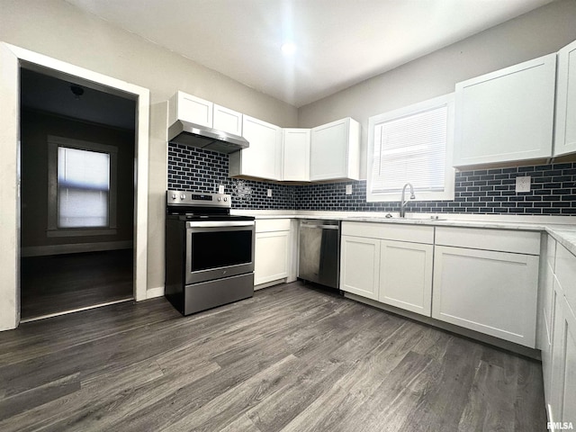 kitchen with white cabinets, sink, stainless steel appliances, and dark wood-type flooring