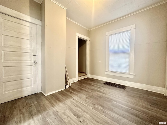 interior space featuring hardwood / wood-style flooring and crown molding