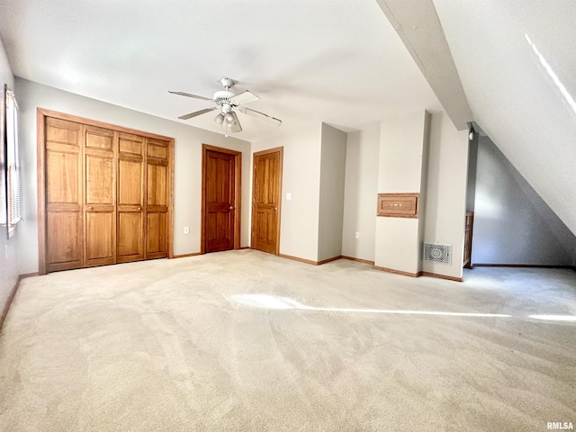 unfurnished bedroom featuring ceiling fan and light carpet