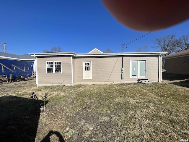 back of house with a lawn