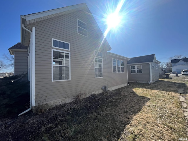 rear view of property featuring a yard