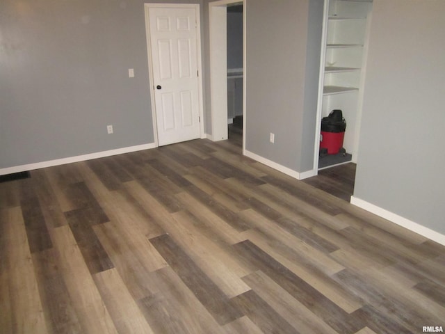 unfurnished bedroom with dark hardwood / wood-style flooring