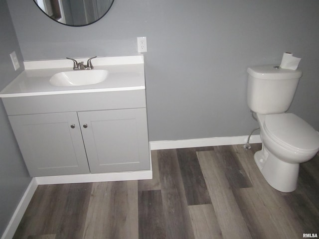 bathroom featuring hardwood / wood-style floors, vanity, and toilet