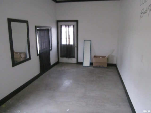 unfurnished room featuring concrete flooring