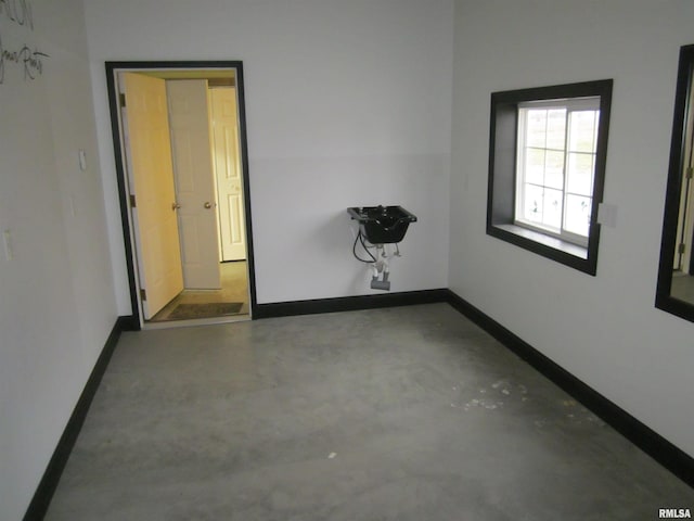 unfurnished room with concrete floors