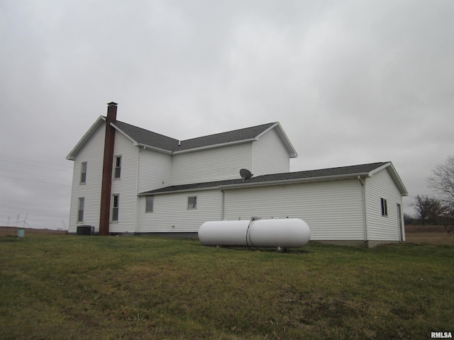 view of property exterior with a lawn and cooling unit