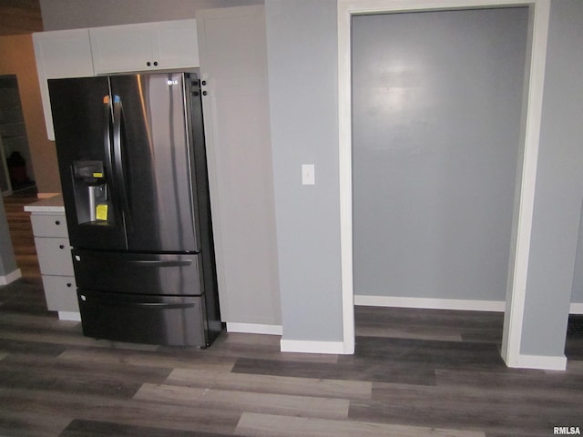 kitchen featuring stainless steel fridge with ice dispenser, white cabinetry, and dark wood-type flooring