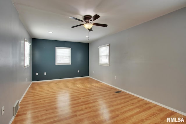 empty room featuring ceiling fan and light hardwood / wood-style flooring