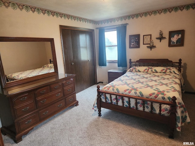 bedroom featuring light carpet and a closet