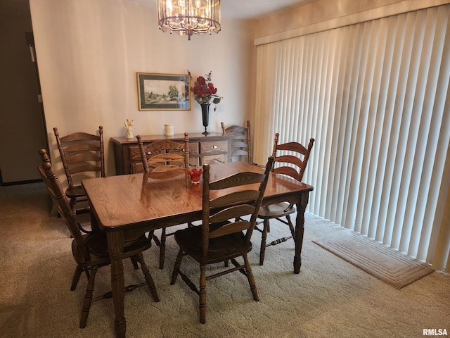 carpeted dining space with a chandelier