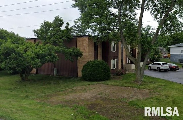 view of side of home featuring a yard