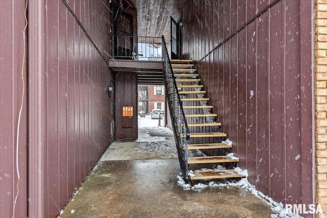 stairs with concrete flooring