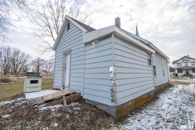 snow covered property featuring a chimney