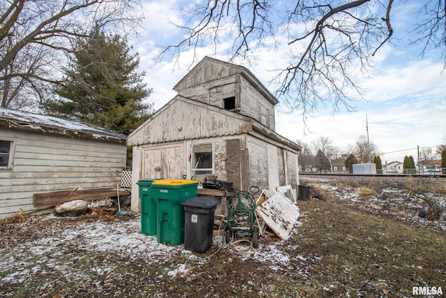 view of property exterior with an outdoor structure