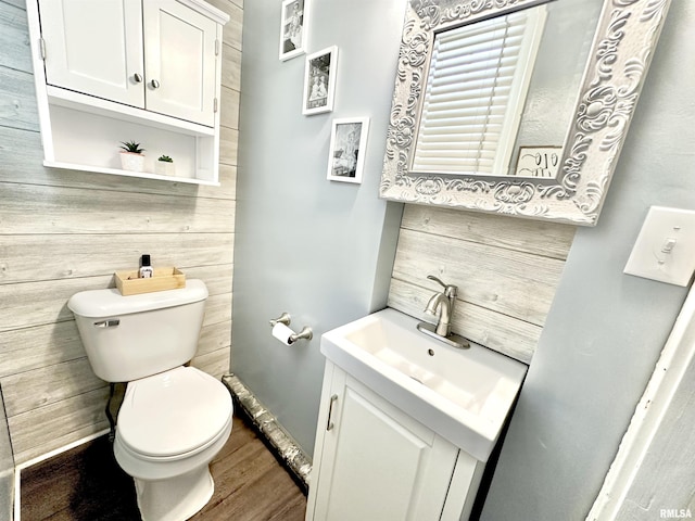 bathroom featuring hardwood / wood-style floors, vanity, and toilet