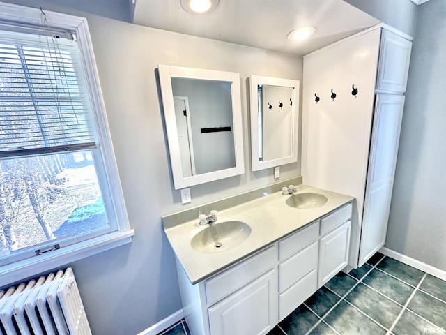 bathroom with tile patterned flooring, vanity, and radiator