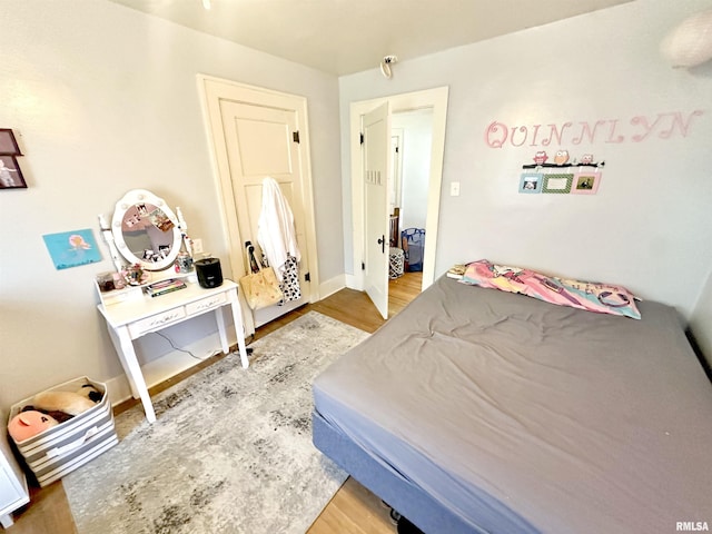 bedroom with hardwood / wood-style flooring