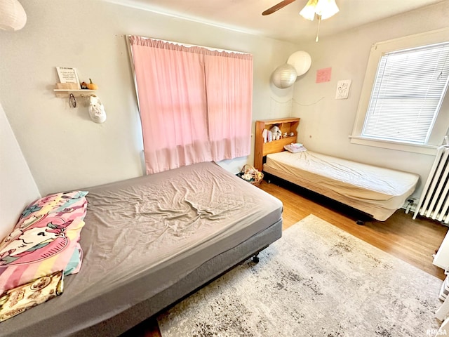 bedroom featuring hardwood / wood-style flooring and ceiling fan