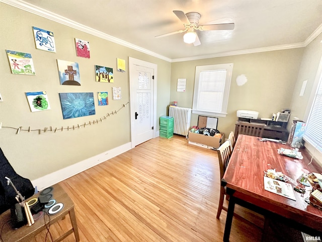 home office with ceiling fan, wood-type flooring, crown molding, and radiator