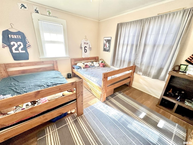 bedroom featuring hardwood / wood-style floors and ornamental molding