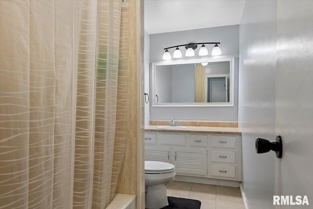 bathroom featuring tile patterned floors, vanity, and toilet