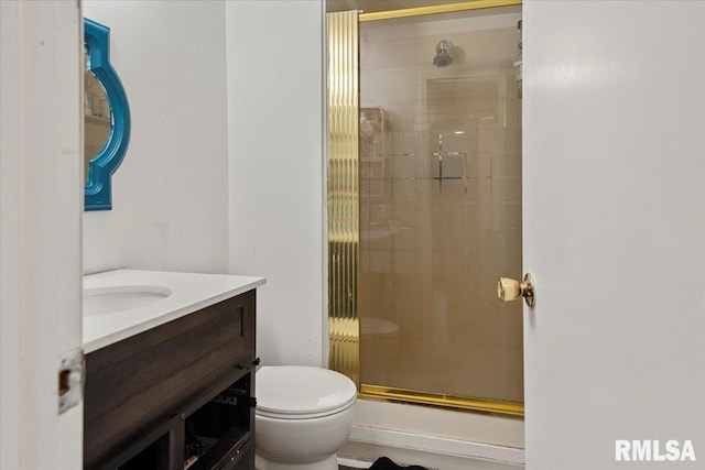 bathroom with vanity, toilet, and a shower with shower door