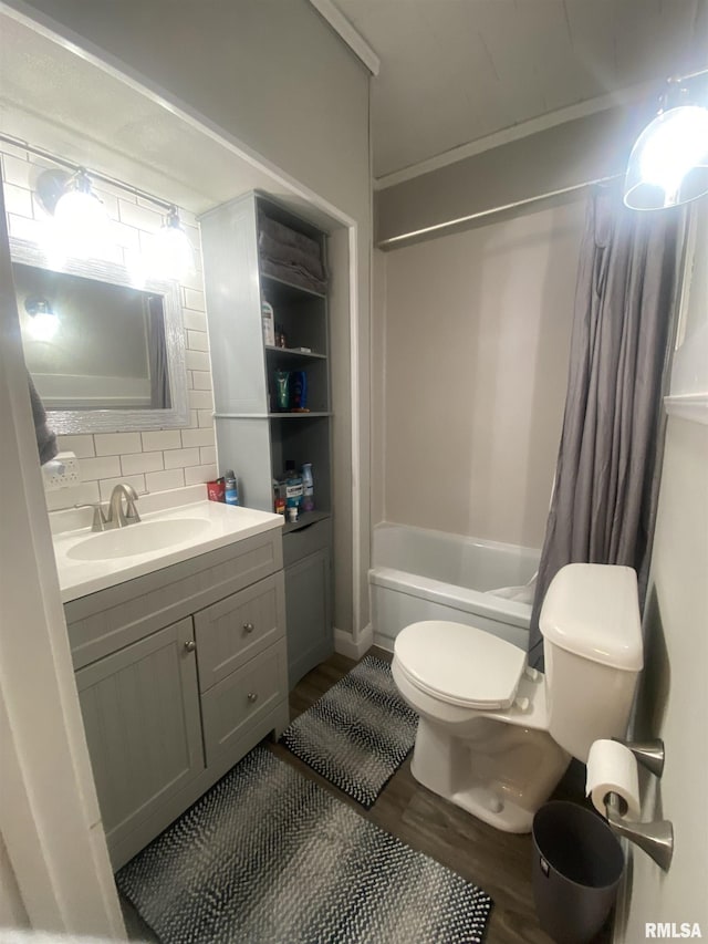 full bathroom featuring vanity, hardwood / wood-style flooring, toilet, tasteful backsplash, and shower / tub combo