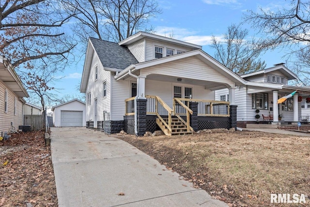 view of front of home featuring a garage, an outdoor structure, and covered porch