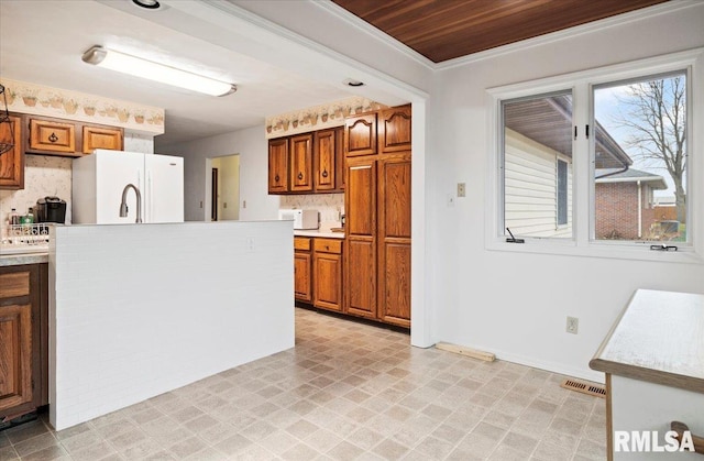 kitchen featuring wooden ceiling, white refrigerator, and crown molding