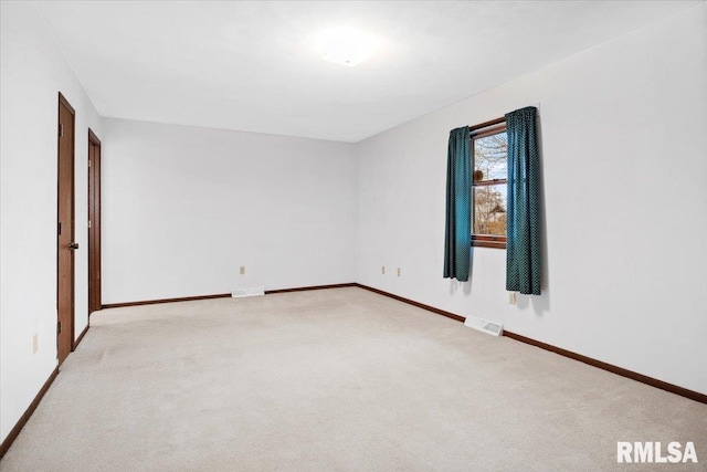 unfurnished room featuring light carpet