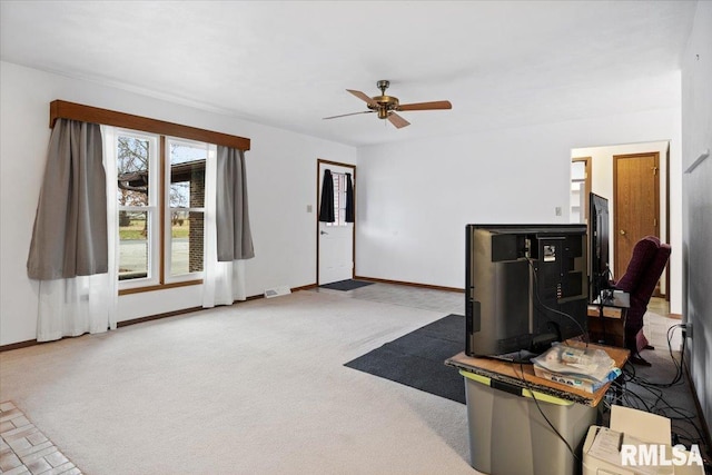 carpeted living room featuring ceiling fan