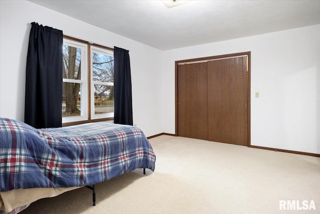 bedroom featuring carpet and a closet