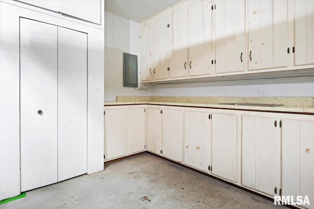 kitchen with white cabinets and electric panel