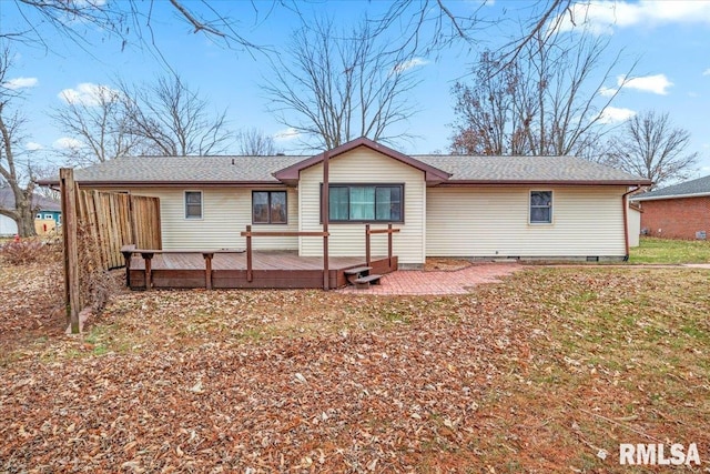 back of house featuring a deck and a patio area