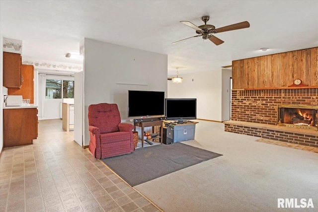 living room with ceiling fan and a brick fireplace