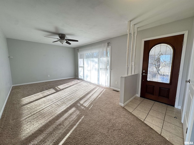 carpeted foyer with ceiling fan