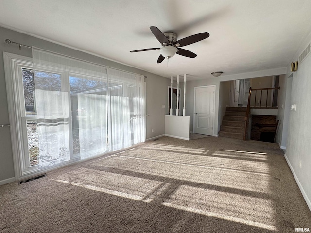 carpeted empty room with ceiling fan and a healthy amount of sunlight