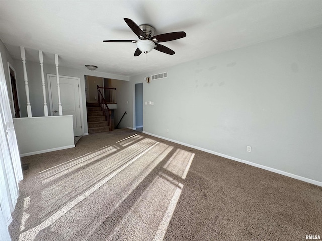 unfurnished room with ceiling fan and carpet