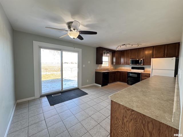 kitchen featuring ceiling fan, dishwasher, white fridge, electric range, and light tile patterned flooring