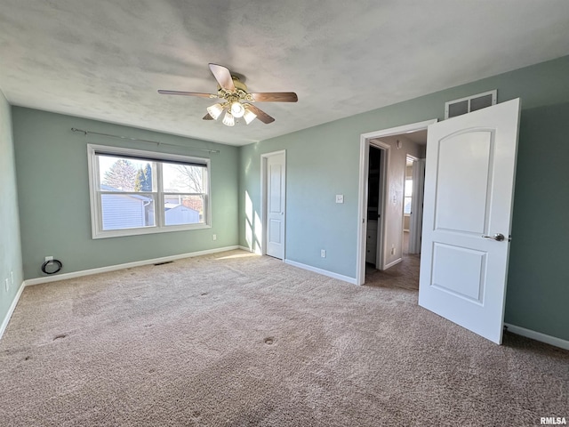 unfurnished bedroom featuring ceiling fan and carpet flooring