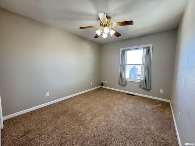 empty room featuring carpet floors and ceiling fan