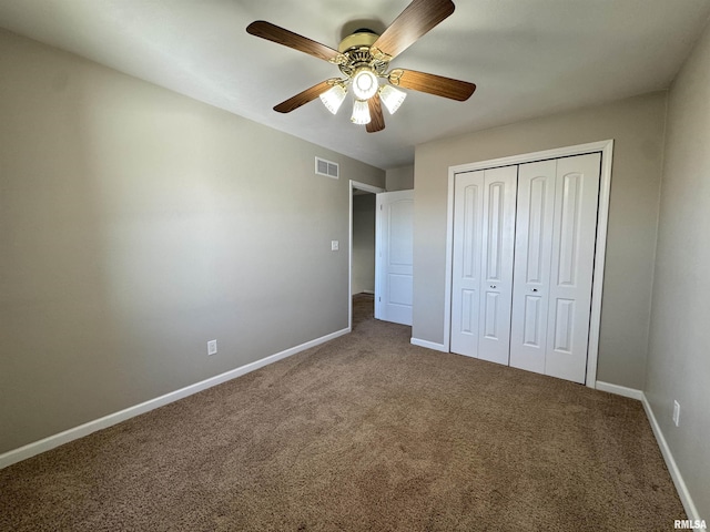 unfurnished bedroom featuring ceiling fan, carpet, and a closet