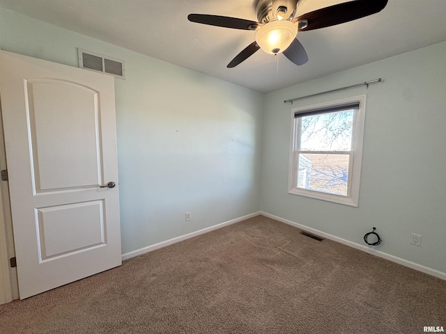 empty room with ceiling fan and carpet floors